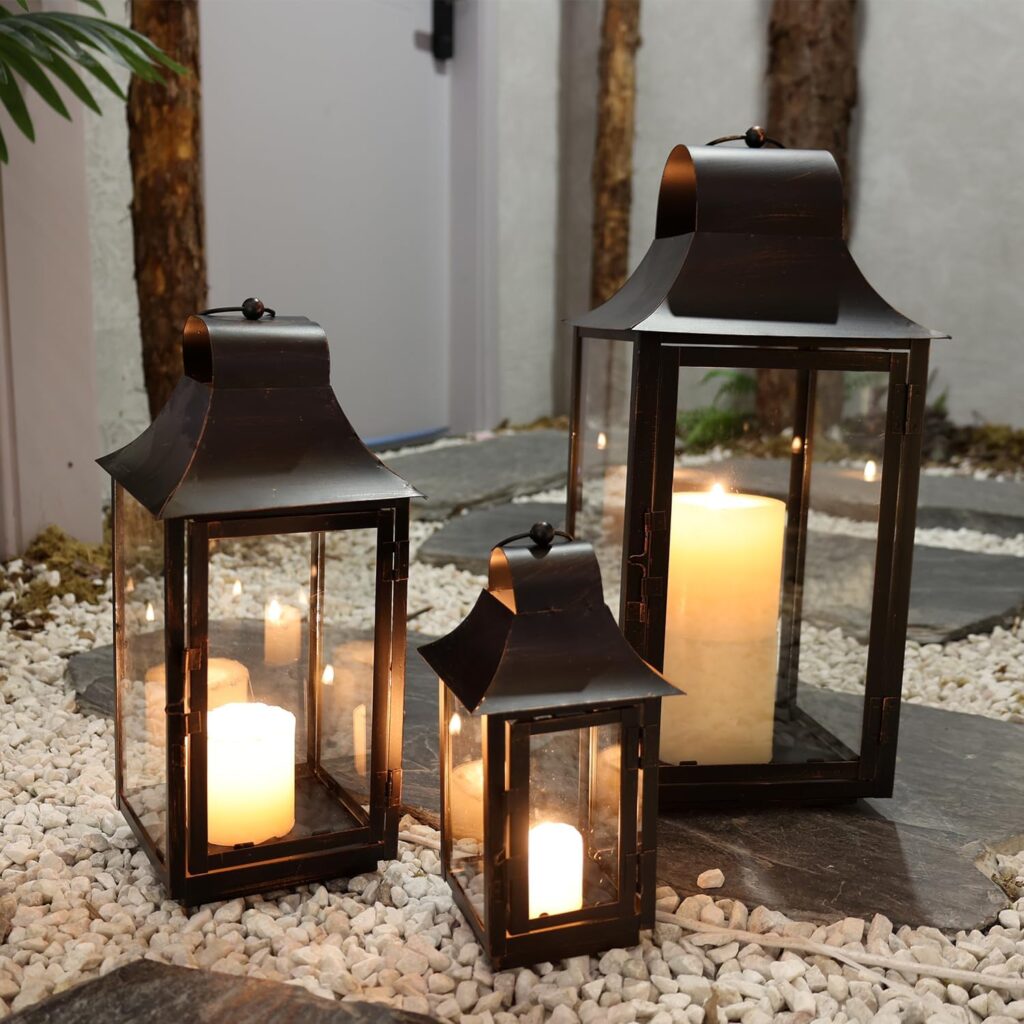 DECORKEY decorative black metal lantern set with intricate cutout patterns and hanging rings displayed on a porch, creating a warm and inviting outdoor ambiance