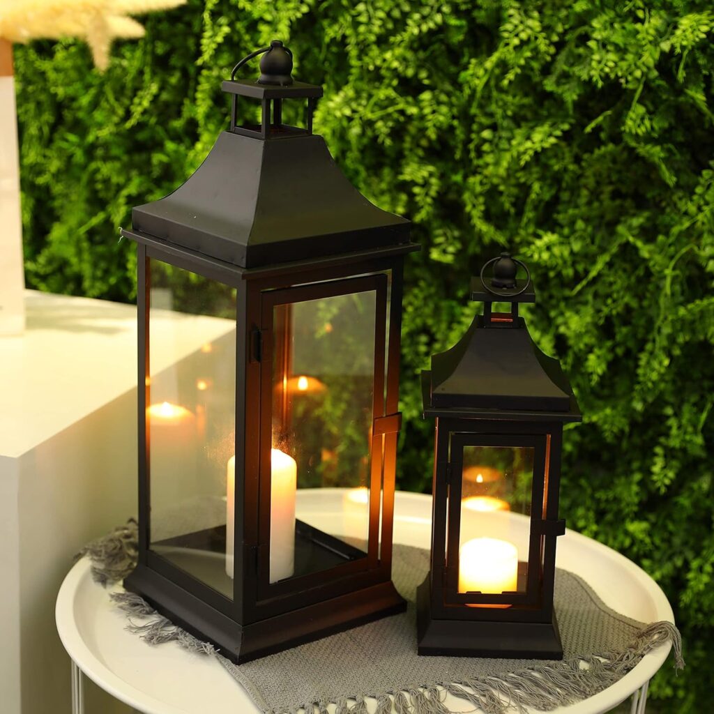 Set of two JHY DESIGN vintage black metal candle lanterns with clear tempered glass panels and hanging rings displayed as rustic farmhouse indoor and outdoor décor