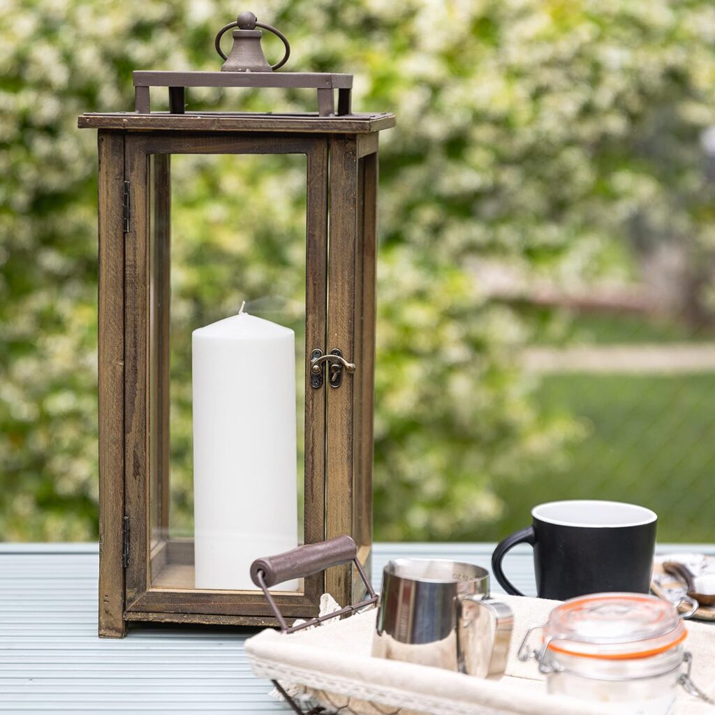 Stonebriar rustic wooden candle lantern with distressed wood frame, clear glass panels, and metal hanging ring displayed as farmhouse-style indoor or outdoor décor