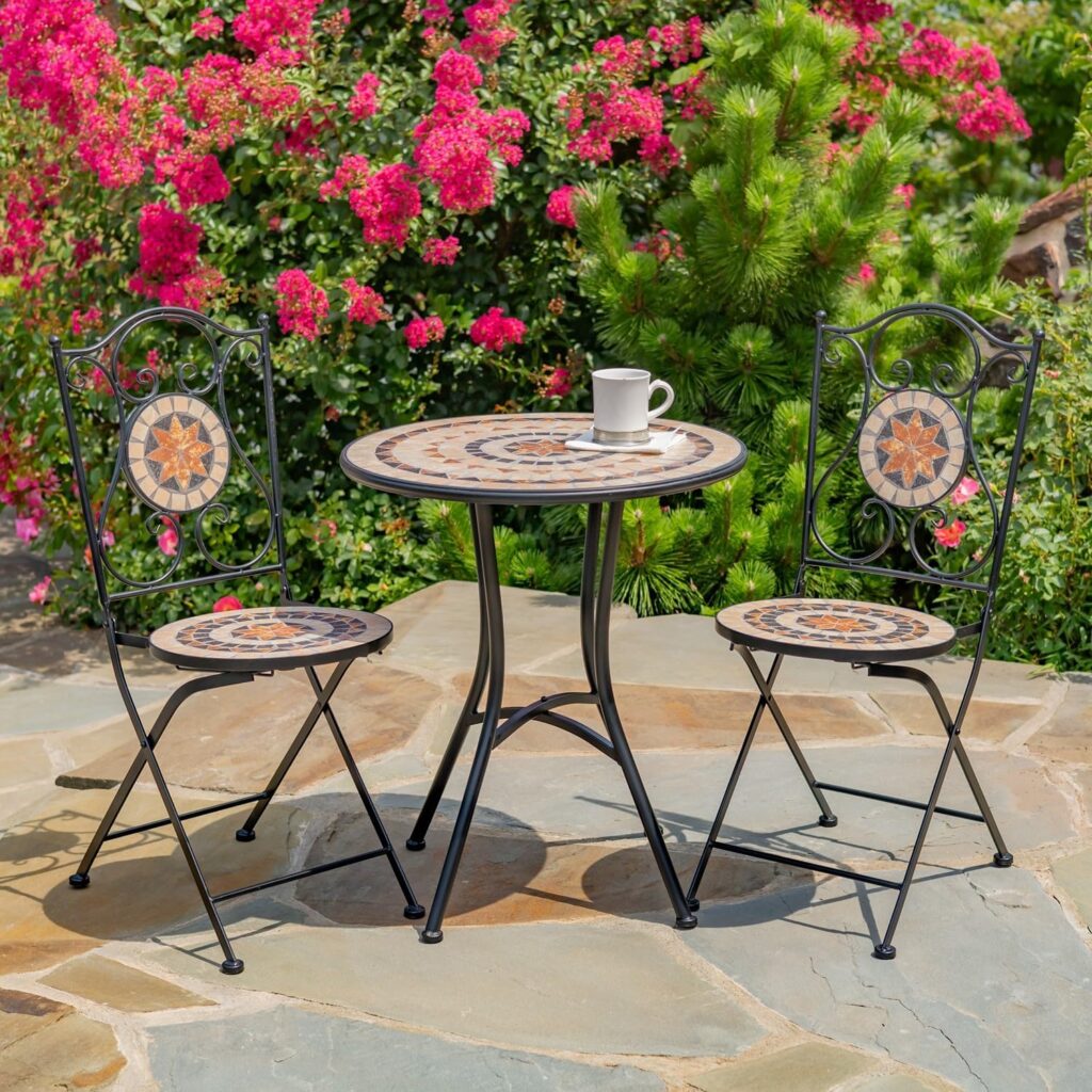 Colorful mosaic tile bistro set with ceramic tabletop and two folding chairs on a garden patio